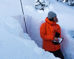 Pallas snowboard guide Christine Feleki assessing snow stability at a backcountry hut in British Columbia